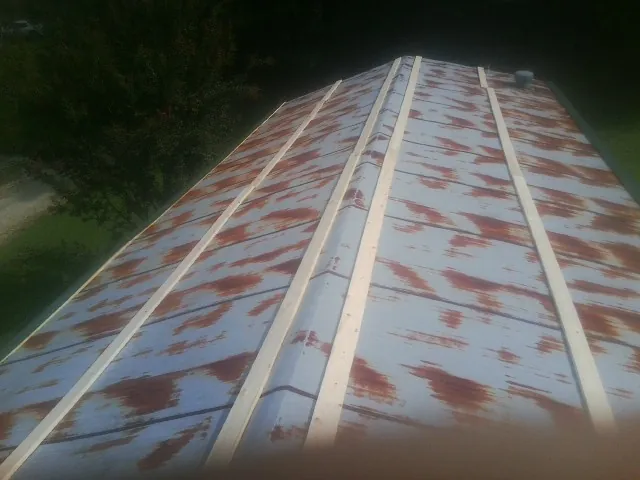 Rusted metal roof panels with new wood purlins before replacement — Storm Damage Roof Repair in Hurley by Roofing Brothers