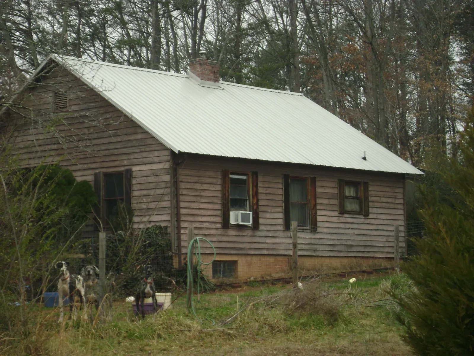 White metal roof on an old wood sided farmhouse, from a Metal Roof Installation job in Hurley
